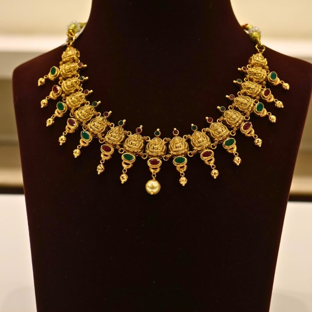 22KT Gold Lakshmi Necklace with Ruby & Green Stone Work (HUID Hallmarked) – Premium Bridal Collection (30.83g)